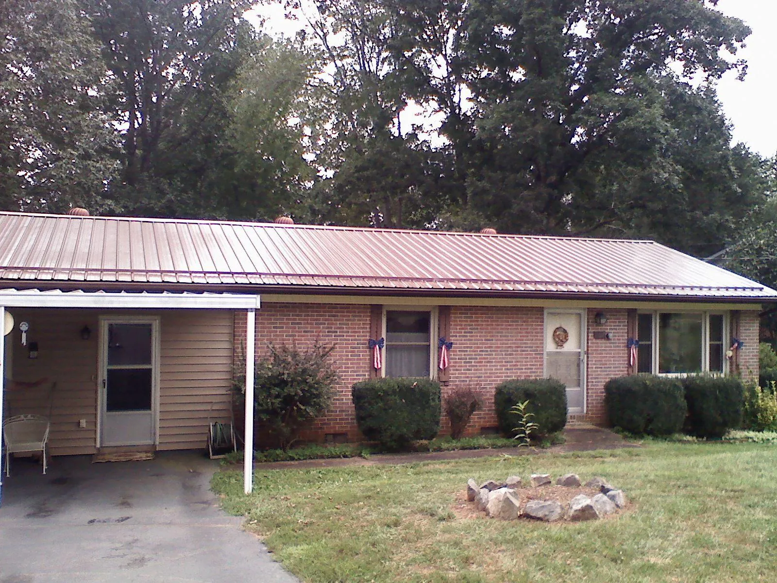 Bronze metal roof and carport on a brick ranch home — Roof Repair work by our crew in Schooleys Mountain